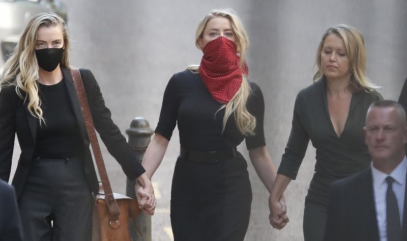 Actress Amber Heard, center, arrives at the High Court in London.  (Photo by Alastair Grant/AP Photo)